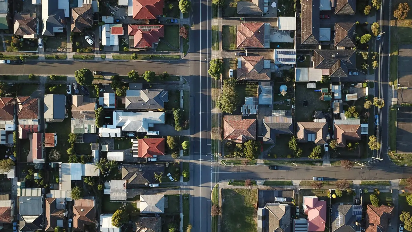 Top-down aerial view of suburban houses in daylight