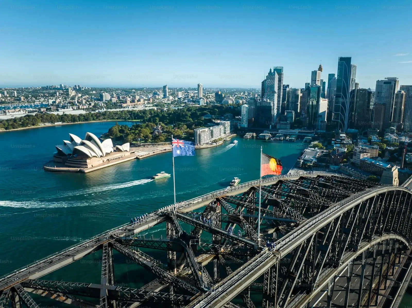Aerial view of the Sydney shoreline with the Opera House, harbour and city towers