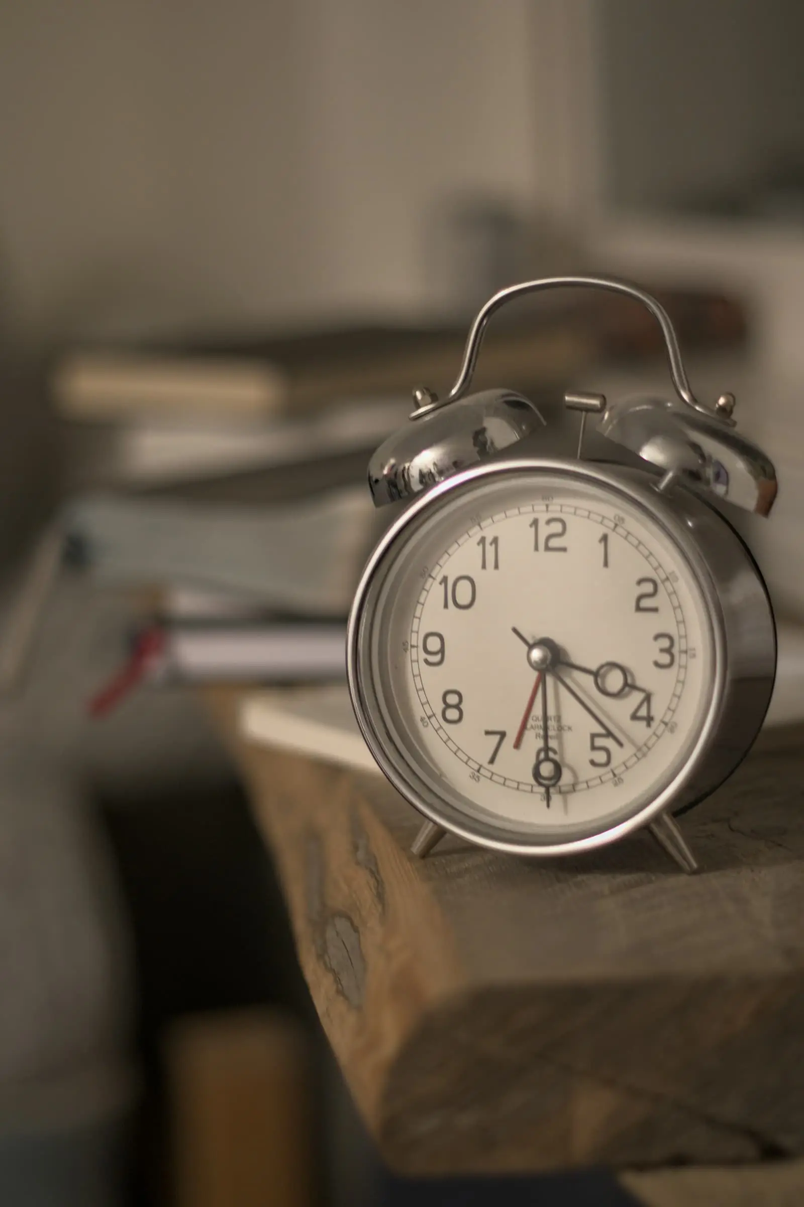 Alarm clock sitting on a wooden block